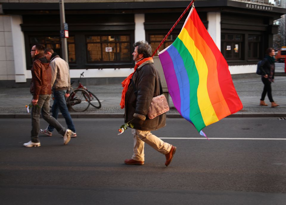 Mann mit Regenbogenflagge