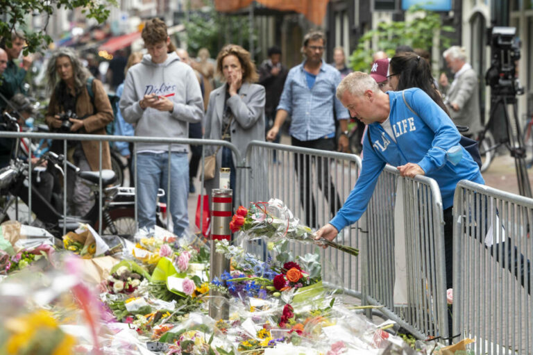 Passanten legen Blumen für den erschossenen Reporter Peter R. de Vries nieder