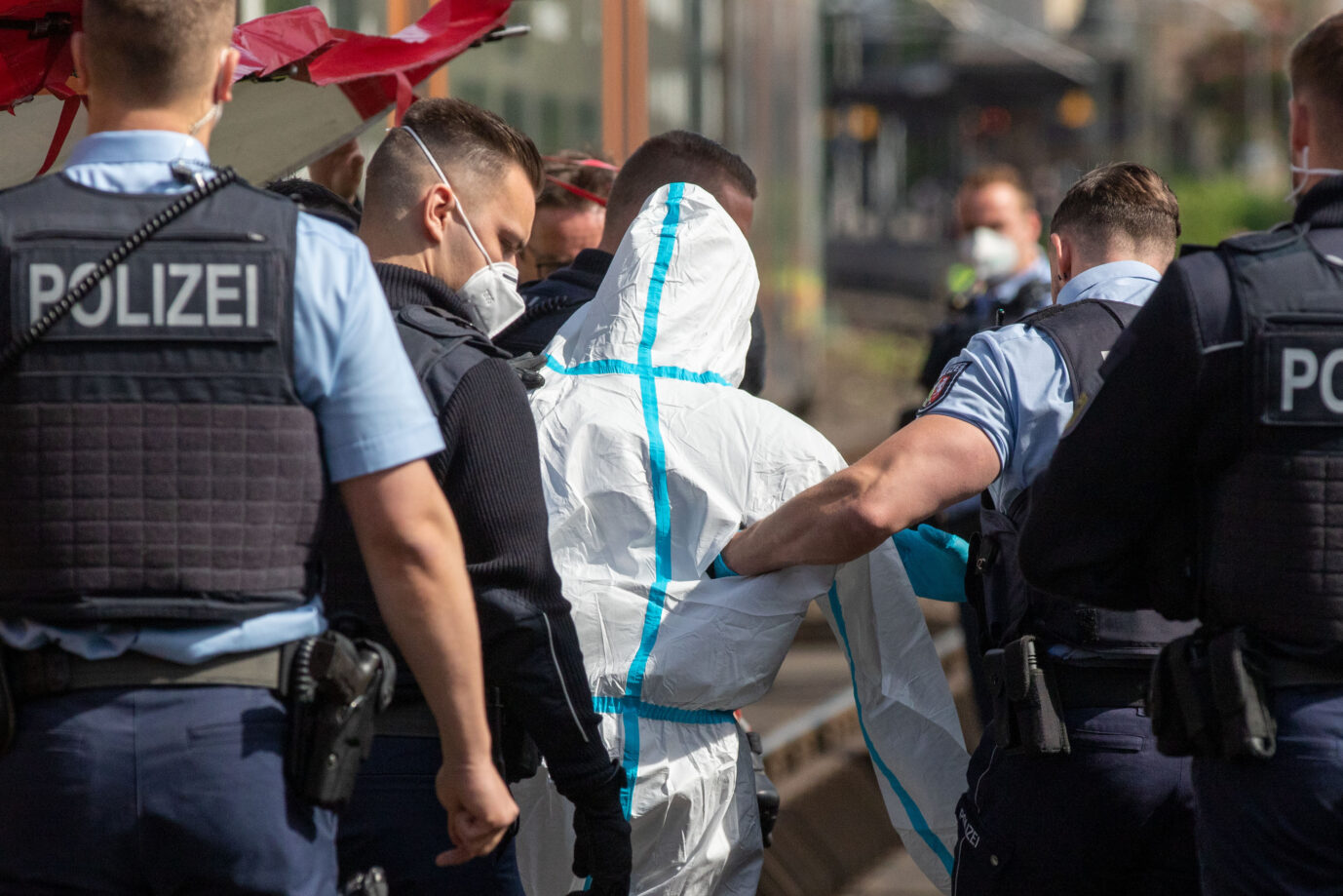 Polizisten führen den Iraker ab, der in einer Regionalbahn bei Aachen mit einem Messer fünf Menschen verletzt haben soll.