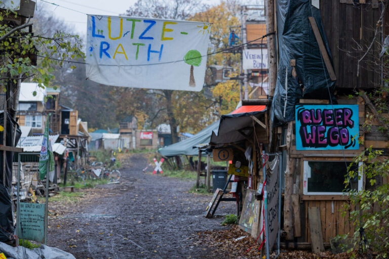 Holzhäuser sind im Protestcamp von selbsternannten Umweltaktivisten zu sehen - an einer Hütte hängt ein Schild "Queer We Go". Das von selbsternannten Klimaschützern besetzte Braunkohledorf Lützerath an der Abrisskante des Braunkohletagebaus Garzweiler II von RWE soll laut Planungen des Innenministeriums wohl Anfang des kommenden Jahres geräumt werden.