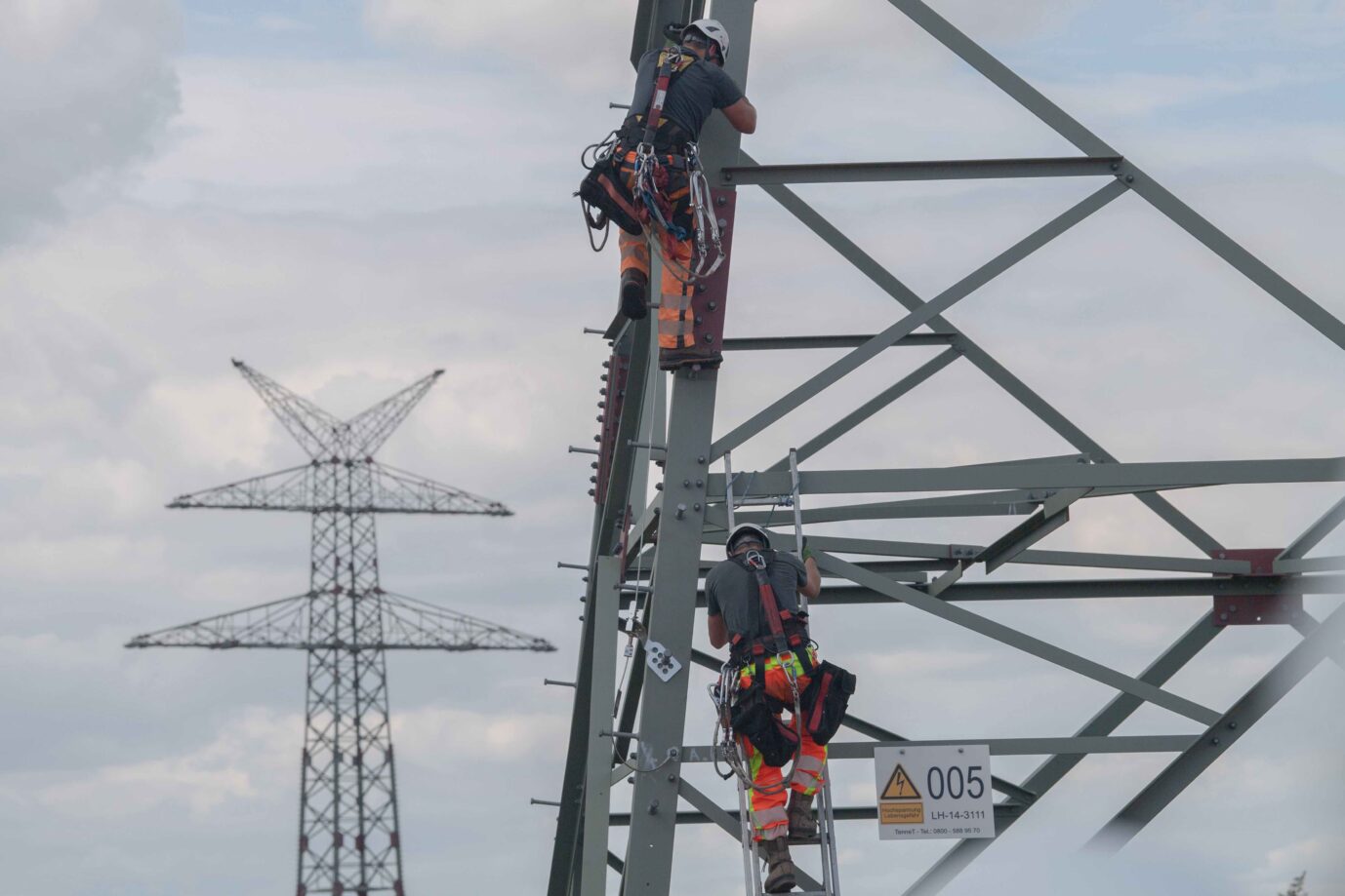 Arbeiter bauen die Hochspannungsleitungsmasten der Stromversorger auf: Energiewende und Stromnetz passen noch nicht recht zusammen.