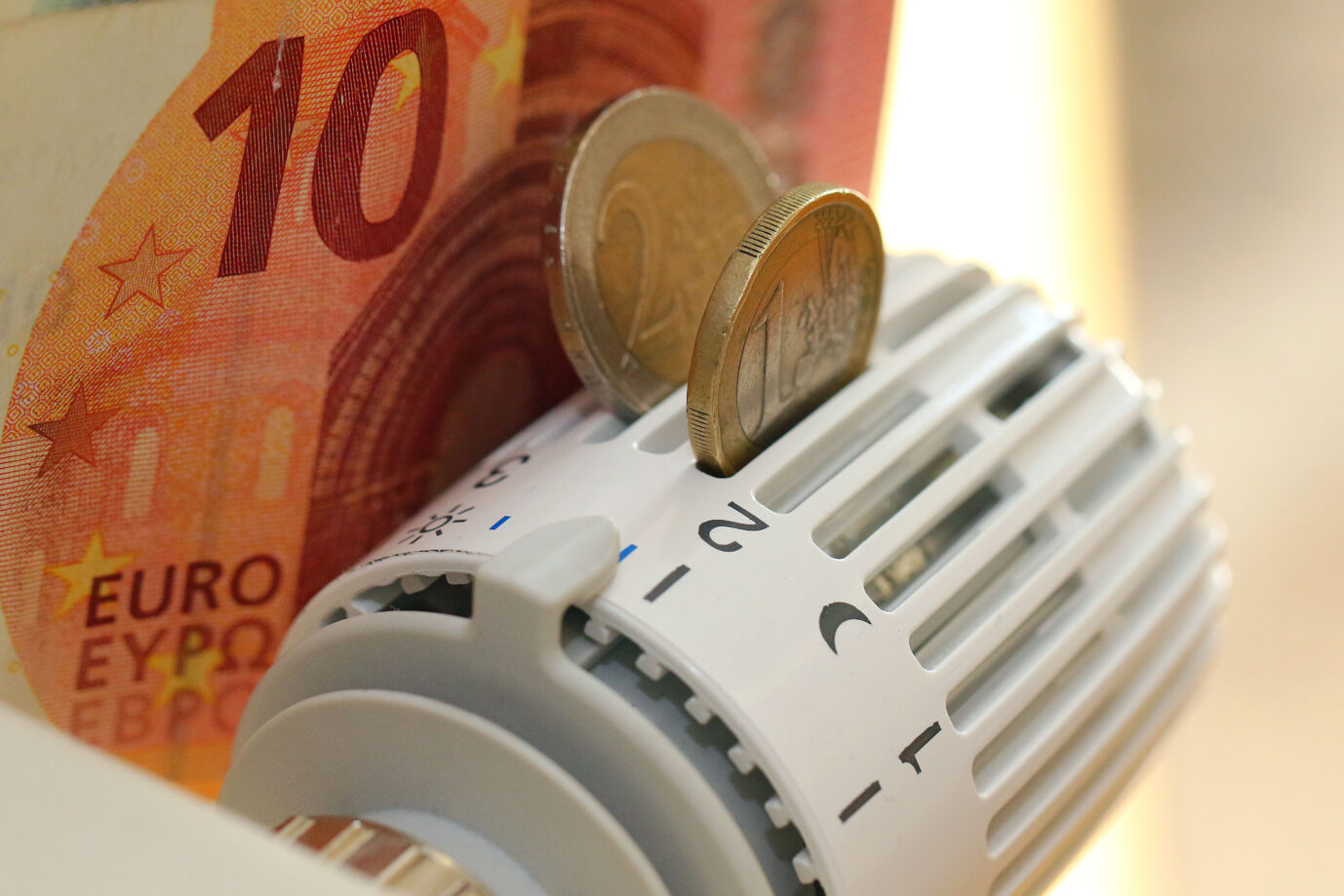 Euronoten und Münzen vor einer Heizung: Die Energiepreise in Deutschland werden weiter steigen, sagt E.on-Chef Leonhard Birnbaum. Es geht um Strompreise.