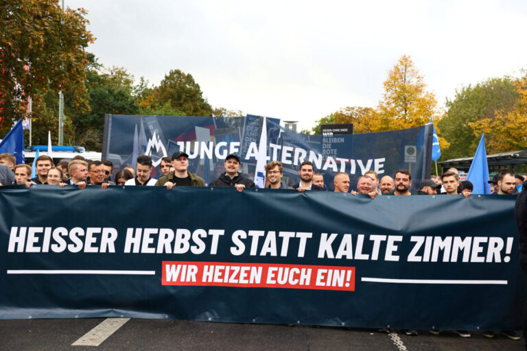 Youth Alternative for Germany (Junge Alternative) demonstrators hold a banner reading "Hot autumn instead of cold rooms! We heat you up" as supporters of Alternative for Germany (AfD) party protest against the government, amid skyrocketing energy prices, in Berlin, Germany, October 8, 2022. REUTERS/Christian Mang