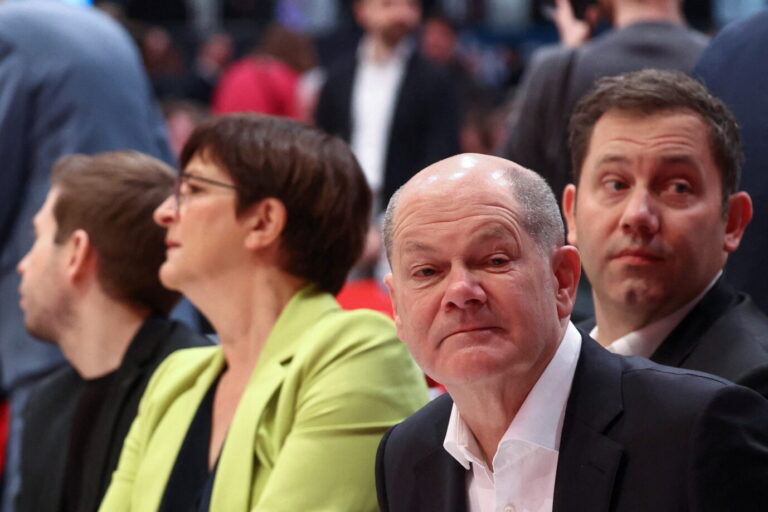 German Chancellor Olaf Scholz takes his seat with Secretary General of Germany's Social Democratic Party SPD Kevin Kuehnert and SPD co-leaders Saskia Esken and Lars Klingbeil during a three-day SPD party convention in Berlin, Germany, December 9, 2023. REUTERS/Liesa Johannssen