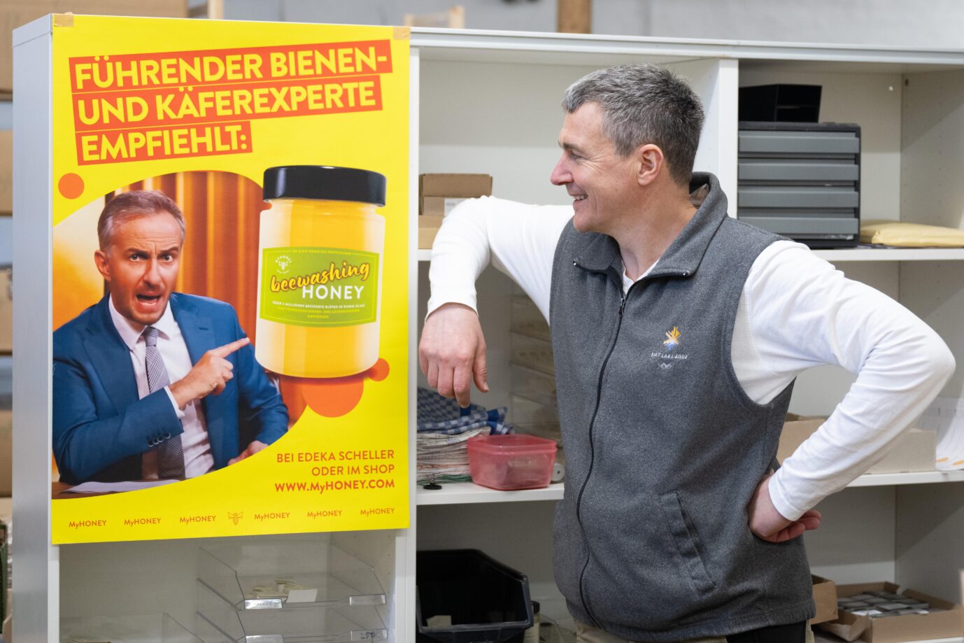 Rico Heinzig, Imker, steht neben einem Plakat mit dem Foto des Moderators Jan Böhmermann. Böhmermann verklagt den Imker auf 20.000 Euro, weil er ungefragt sein Bild und seinen Namen genutzt hat.