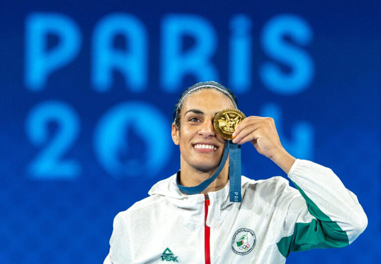 PARIS, FRANCE - AUGUST 09: Imane Khelif of Team Algeria celebrates as she wins gold medal after defeating Liu Yang (blue) of China in the Boxing Women's 66kg Final match on day fourteen of the Olympic Games Paris 2024 at Roland Garros on August 09, 2024 in Paris, France. Aytac Unal / Anadolu