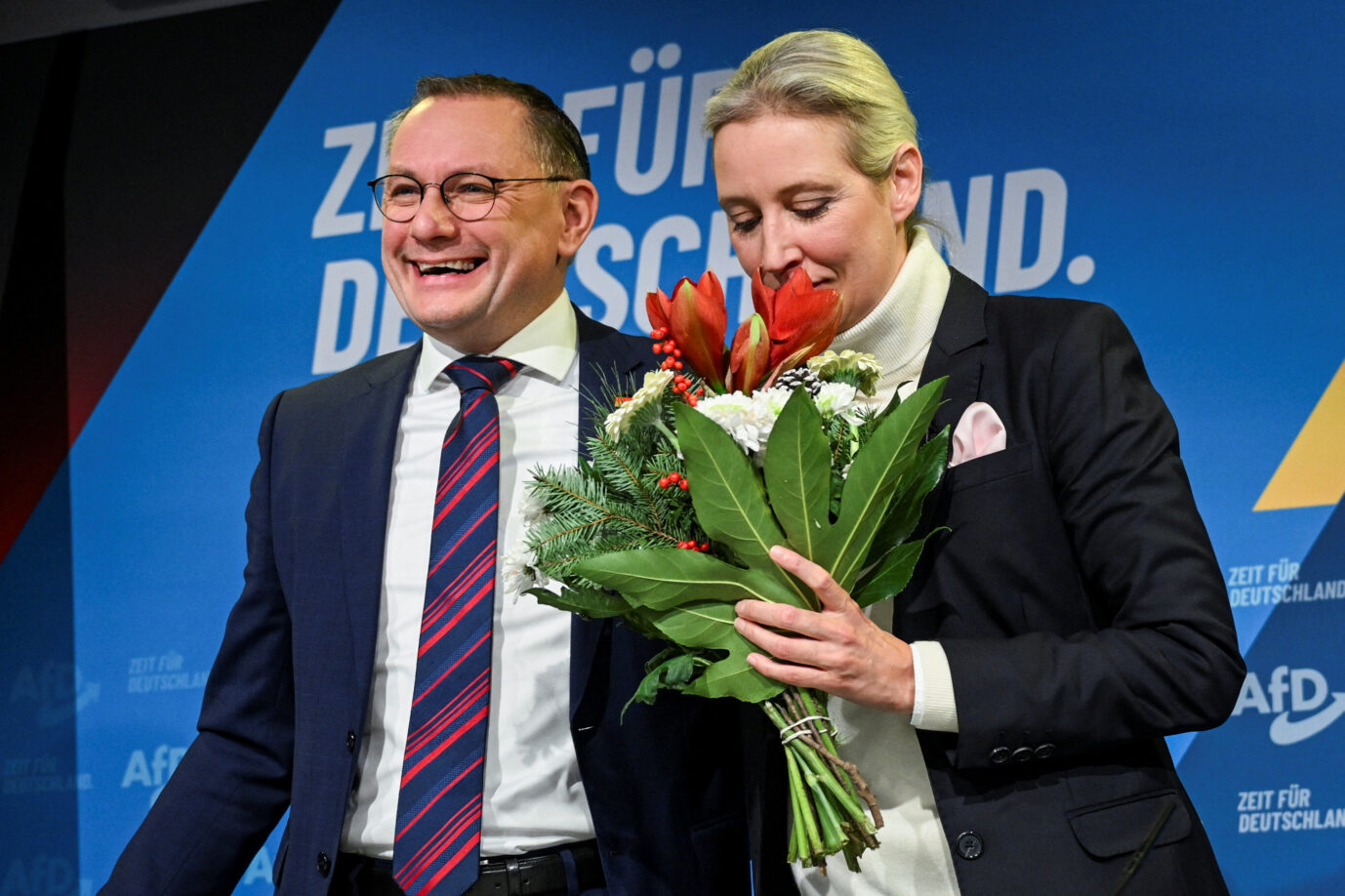 Alice Weidel, co-leader of the Alternative for Germany party (AfD), holds flowers at a press conference as she stands next to Tino Chrupalla, co-leader of AfD, on the day Weidel is expected to be announced as officially nominated candidate for Chancellor for the upcoming general elections, in Berlin, Germany December 7, 2024. REUTERS/Annegret H