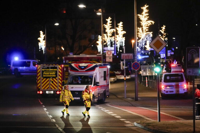 Rettungskräfte stehen vor dem Weihnachtsmarkt in Magdeburg, wo ein Mann aus Saudi-Arabien mit einem Wagen in die Menschenmenge raste.