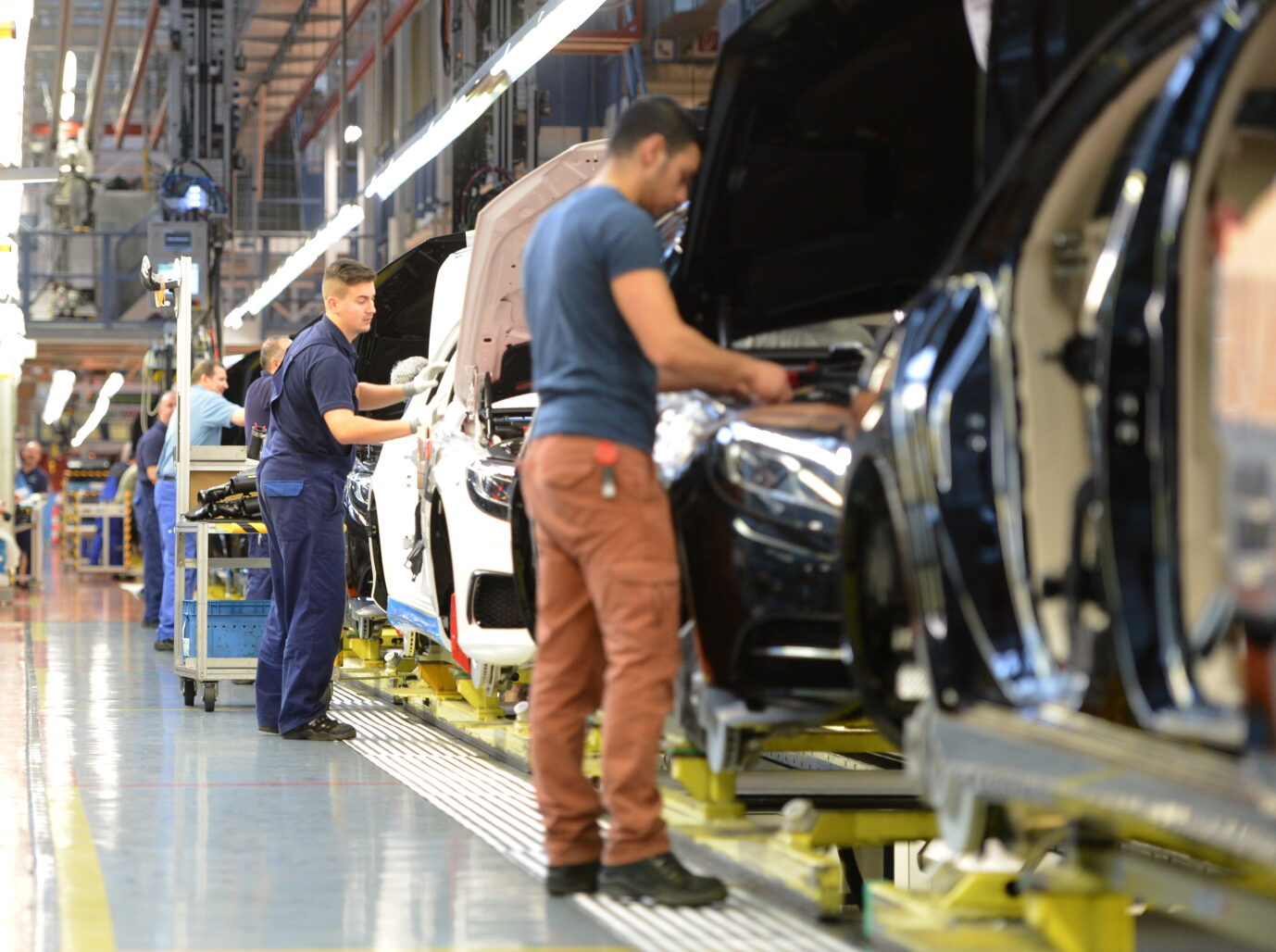 Arbeiter an einem Produktionsband in der Autoindustrie.