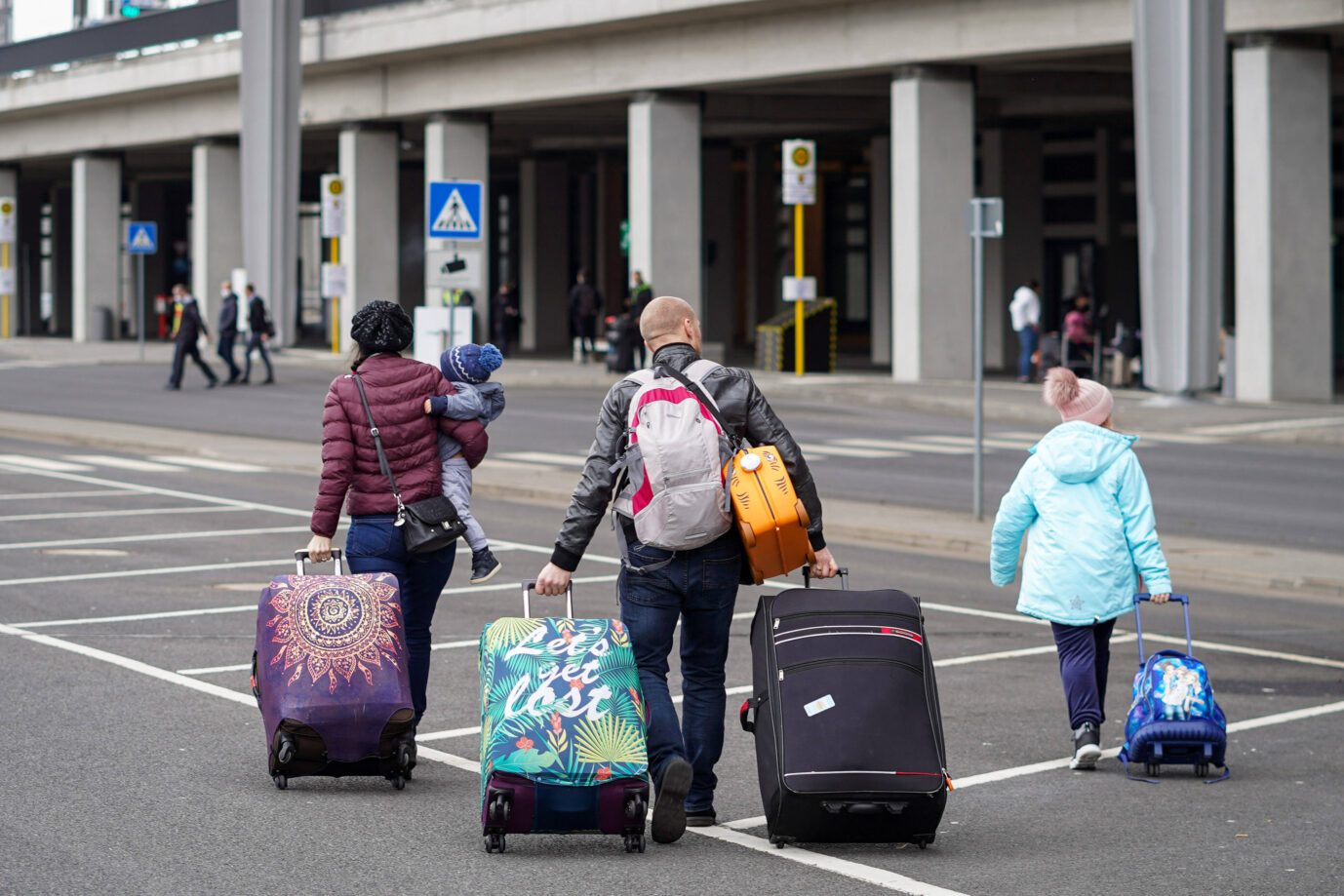 Eine Familie tritt die Reise am Flughafen BER bei Berlin an. Nur wenige Syrer nehmen dafür die Hilfe des Bundes in Anspruch (Symbolbild). Foto: IMAGO / Stefan Zeitz