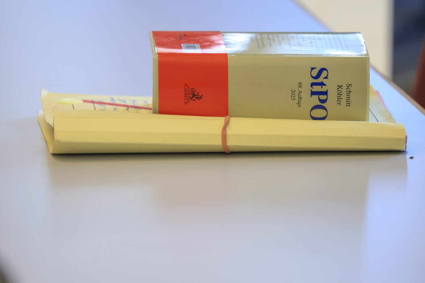 Ein aufgeschlagenes Gesetzbuch und Akten auf einem Tisch. Der Fall betrifft die Entscheidung der Staatsanwaltschaft Detmold, keine Ermittlungen gegen den AfD-Politiker Jirka Möller aufzunehmen. Gesetzestexte der Strafprozeßordnung auf einem Tisch: Die Staatsanwaltschaft Detmold sieht im Fall Jirka Möller keinen Straftatbestand – auch keine Volksverhetzung. Foto: picture alliance/dpa | Jan Woitas