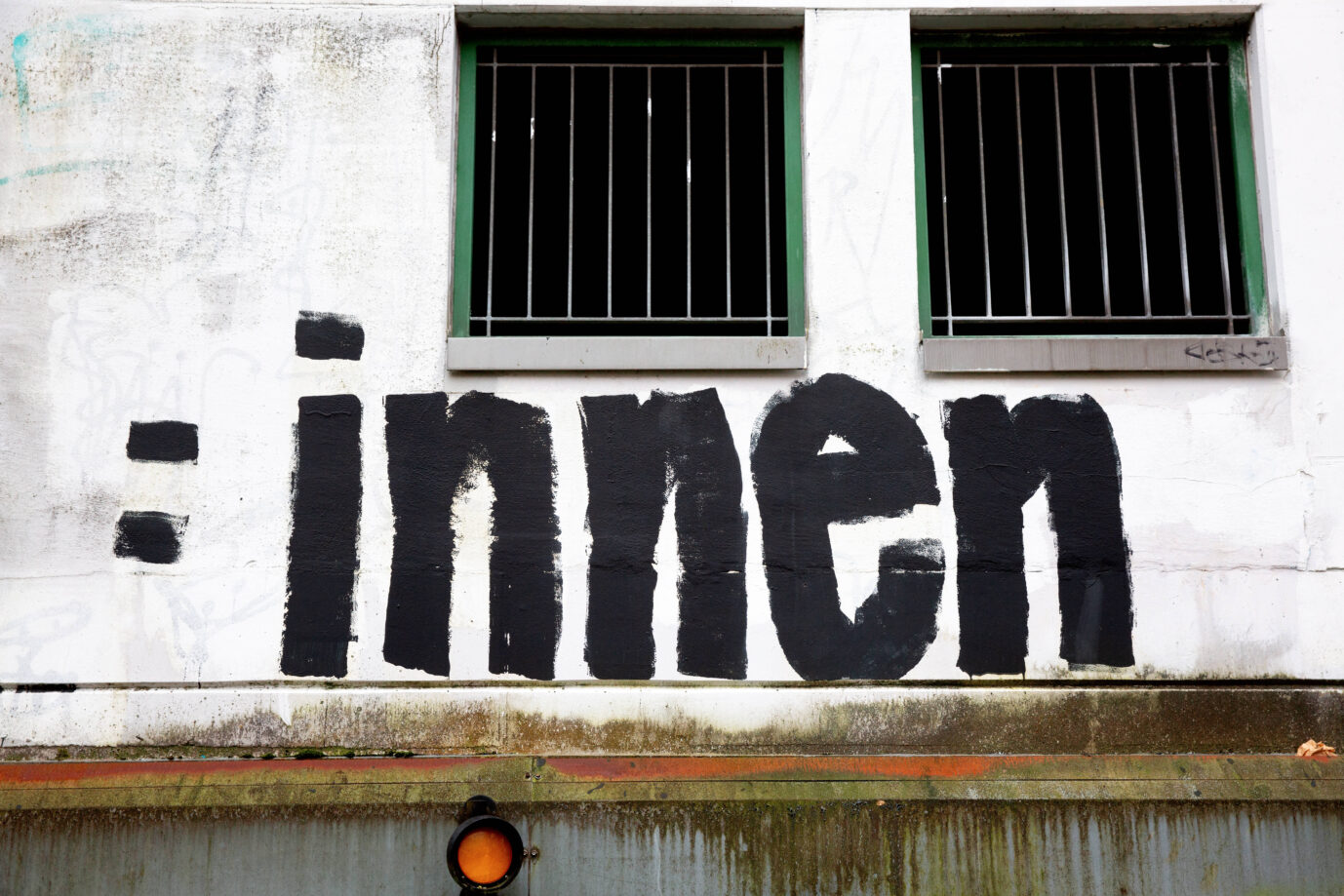 An eine weiße Hauswand hat jemand ein Graffiti zum Thema Gendern gesprüht – damit verändert sich in die Sprache