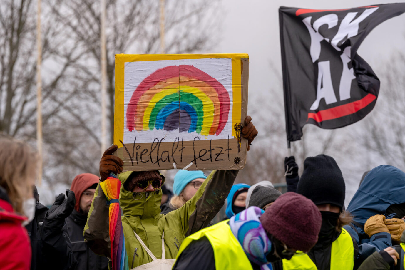 Demonstrant mit Schild "Vielfalt fetzt!" bei einer Blockade auf einer Zufahrt zur WT Energiesysteme Arena, wo am Wochenende vom 10.-11. Januar der AfD Parteitag stattfindet. Ein breites Bündnis hatte zu Gegenprotesten gegen die rechtsextreme Partei aufgerufen. Blockiert wurden insbesondere die Zufahrtswege, wodurch sich der Beginn des Parteitages etwa 2 Stunden nach hinten verschob. Protest gegen den AfD-Parteitag in Riesa: Auch in Gießen dürfen Linke in Hörweite der Halle. Foto: picture alliance / PIC ONE | Bastian Stock
