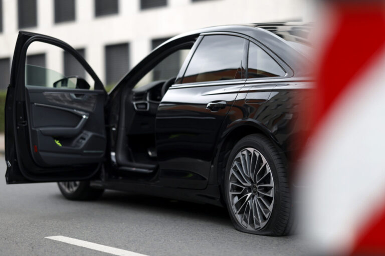 Eine Limousine der Polizei NRW ist beim NRW-Tag im Kölner Rheinauhafen über eine Spitze an einer Sicherheitssperre gefahren und hat dadurch einen Platten Reifen. Köln, 17.08.2024. Eine Limousine mit einem platten Reifen (Symbolbild): Laut dem Widerstands-Kollektiv belasteten die angegriffenen Fahrzeuge das Klima und die Umwelt. Foto: picture alliance / Panama Pictures | Christoph Hardt. Das Widerstands-Kollektiv gründete sich im Februar 2025 und diente als Nachfolgeorganisation der „Letzte Generation“.